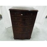 A serpentine front, mahogany chest of drawers, approximately 91 cm x 53 cm x 37 cm.