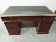 A partners desk having one central drawer flanked by four either side,