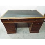 A partners desk having one central drawer flanked by four either side,
