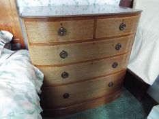 A bow front chest of two over three drawers measuring approximately 97 cm x 95 cm x 59 cm.