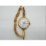 A lady's 15ct gold cased wristwatch on expanding bracelet stamped 15c,