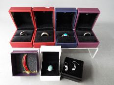 Six rings and a pair of earrings, stamped 925 and 'Sterling Silver', all boxed.