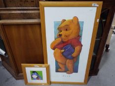 Two framed Disney Winnie The Pooh prints, largest approximately 98 cm x 53 cm.