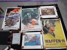 A small collection of military related posters and similar, including a Waffen SS,