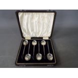 A boxed set of six silver coffee bean spoons