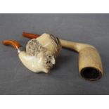 A meerschaum pipe, the bowl carved in the form of a gentleman's head and one other.