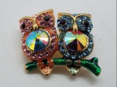 Butler & Wilson - a Butler & Wilson stone set brooch in the form of two owls sitting on a branch,
