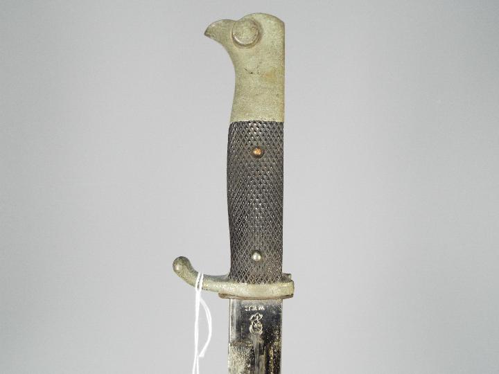 A German dress bayonet with 9 3/4" blade with WKC makers mark, black composite grip, with scabbard. - Image 3 of 5