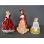 Three Paragon figurines, two depicting a lady and one of a child sitting on a rock.