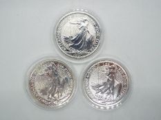 Three silver 1 ozt, .999 fineness 2020 Britannia £2 coins contained in capsules.