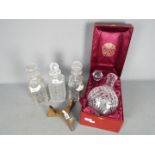 Four decanters, two with ceramic bottle labels (whisky and gin),