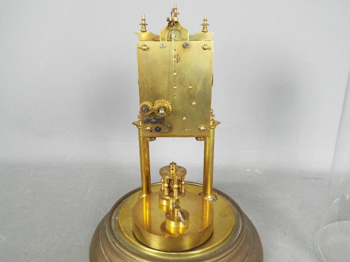 A brass torsion clock with disc pendulum, under glass dome, approximately 31 cm (h). - Image 6 of 6