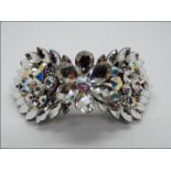 Butler & Wilson - a Butler & Wilson stone set hair clip with centre flower,