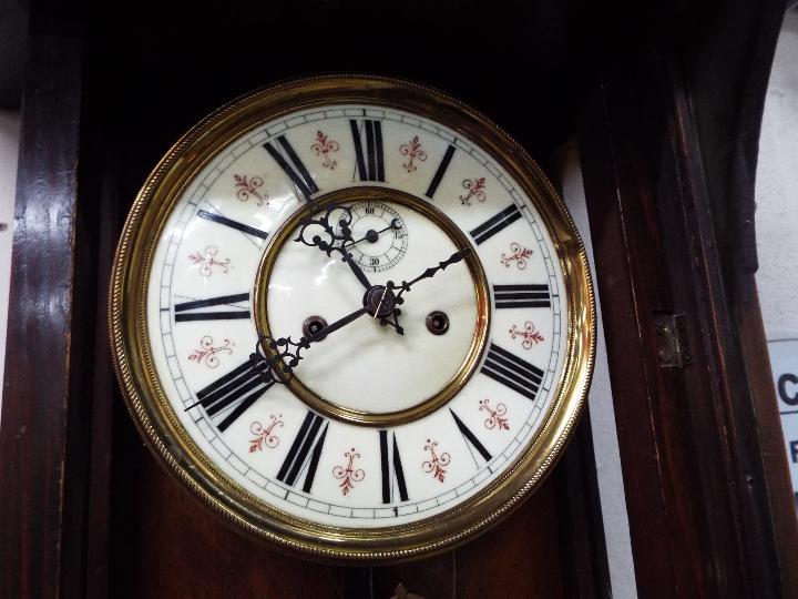 A highly carved walnut double weight Vienna wall clock with ceramic dial and pendulum - Image 4 of 6