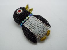 Butler & Wilson - a Butler & Wilson stone set brooch in the form of a penguin,
