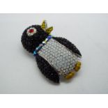 Butler & Wilson - a Butler & Wilson stone set brooch in the form of a penguin,