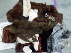 A vintage suitcase containing a quantity of furs,