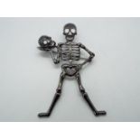 Butler & Wilson - a large Butler & Wilson stone set brooch in the form of a skeleton holding a