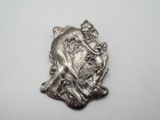 A white metal art nouveau style brooch in the form of a lady