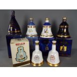 Six commemorative Bells ceramic whisky decanters (with contents) comprising four 70cl and two 50cl,