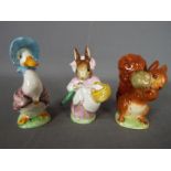 Beswick - Three Beatrix Potter figurines comprising Mrs Rabbit,