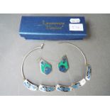 A silver necklace and earrings set