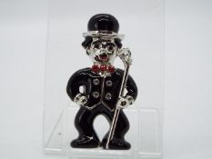 Butler & Wilson - a Butler & Wilson enamel and stone set brooch in the form of Charlie Chaplin,