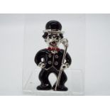 Butler & Wilson - a Butler & Wilson enamel and stone set brooch in the form of Charlie Chaplin,