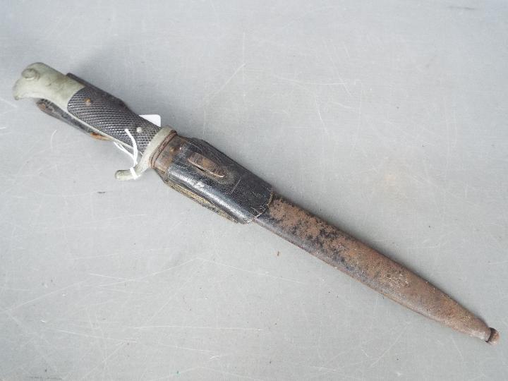 A German dress bayonet with 9 3/4" blade with WKC makers mark, black composite grip, with scabbard. - Image 5 of 5