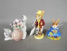 Two Royal Doulton figurines comprising Daisie Bunnykins, Mr Bunnykins and a Lladro kitten,