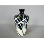 Moorcroft - a Moorcroft vase in the Twenty Winters design,