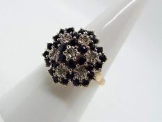 A 9ct gold and sapphire cluster ring, size O, approximately 3.8 grams all in.