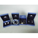 Swarovski - Four boxed Swarovski jewellery items comprising earrings and necklaces.