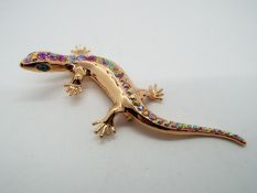 Butler & Wilson - a Butler & Wilson rose gold coloured stone set brooch in the form of a lizard,