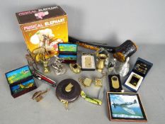 A mixed lot of collectables to include cigarette lighters, pens, penknife, musical keyrings,