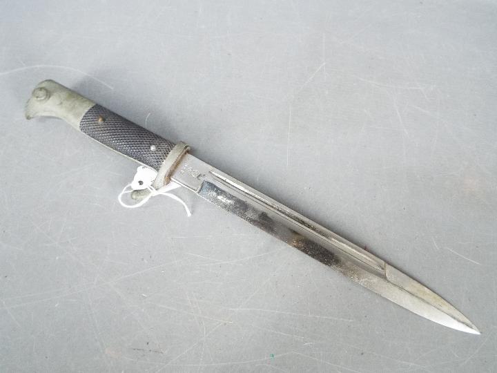 A German dress bayonet with 9 3/4" blade with WKC makers mark, black composite grip, with scabbard. - Image 2 of 5