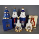 Five commemorative Bells ceramic whisky decanters (with contents) comprising four 75cl and one 70cl,