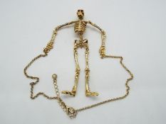 Butler & Wilson - a Butler & Wilson necklace in the form of a hanging skeleton with Butler & Wilson