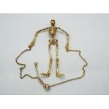 Butler & Wilson - a Butler & Wilson necklace in the form of a hanging skeleton with Butler & Wilson