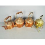 Three copper kettles and a brass spirit kettle and stand.