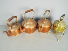 Three copper kettles and a brass spirit kettle and stand.