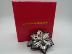 Butler & Wilson - a Butler & Wilson stone set hair clip in the form of a flower,