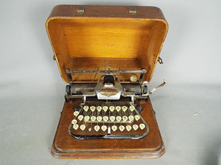 An early 20th century, aluminium 'Featherweight' Blickensderfer typewriter in carry case.