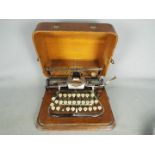 An early 20th century, aluminium 'Featherweight' Blickensderfer typewriter in carry case.