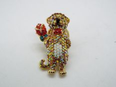 Butler & Wilson - a Butler & Wilson stone set pin in the form of a teddy bear,