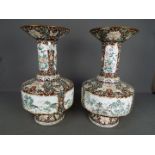 A large pair of Chinese enamel vases decorated to the body with panels of landscape scenes,