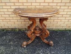 A demilune, fold over card table on highly carved, castored, base,