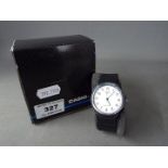 A gentleman's Casio quartz wristwatch with white dial, contained in original box.