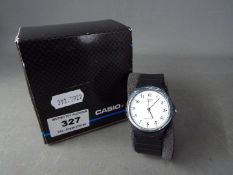 A gentleman's Casio quartz wristwatch with white dial, contained in original box.