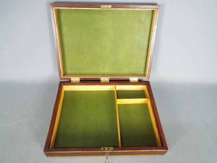 A good quality inlaid wooden box with sectional interior and key,